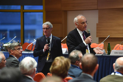 Two presenters standing speaking to audience